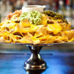 platter of nachos on a bar