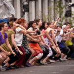 people participating in dance lesson outside